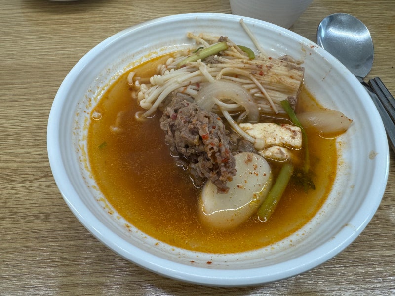 Individual bowl of bulnak jeongol with beef, tofu, mushrooms, and broth